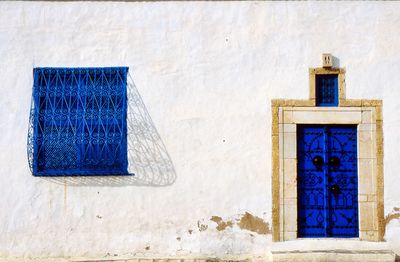 Blue window on wall of building