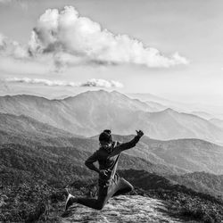 Man on mountain against sky