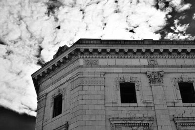 Low angle view of building against cloudy sky