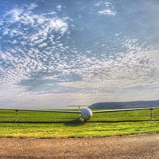 field, sky, grass, landscape, cloud - sky, transportation, rural scene, tranquil scene, grassy, green color, scenics, tranquility, agriculture, nature, cloudy, beauty in nature, cloud, farm, mode of transport, outdoors