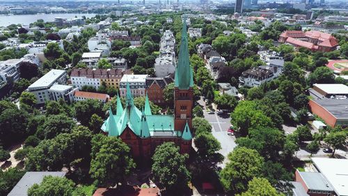 High angle view of trees and buildings in town