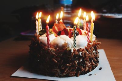 Close-up of candles on cake at table
