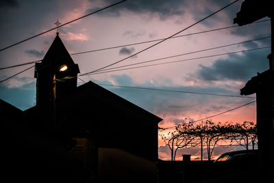 Low angle view of silhouette building at sunset