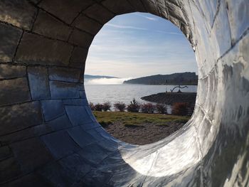 Scenic view of sea against sky seen through window