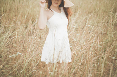 Rear view of woman standing in grass