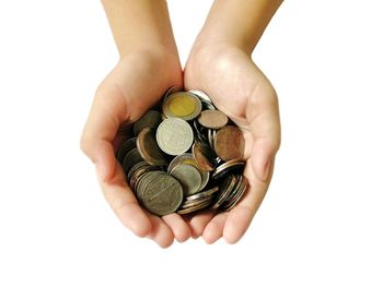 Close-up of hand holding coins