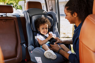 Mother with son sitting in car