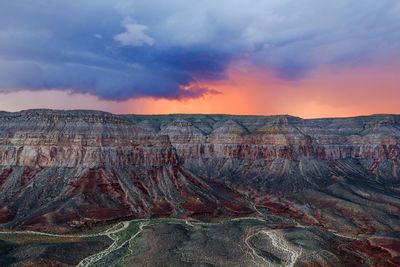 Scenic view of mountains against cloudy sky