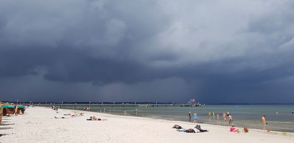 People on beach against sky