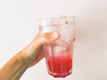 Close-up of hand holding drink glass