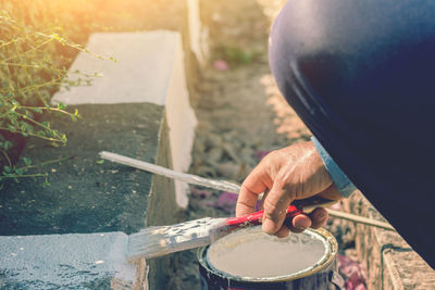 Midsection of man painting barrier