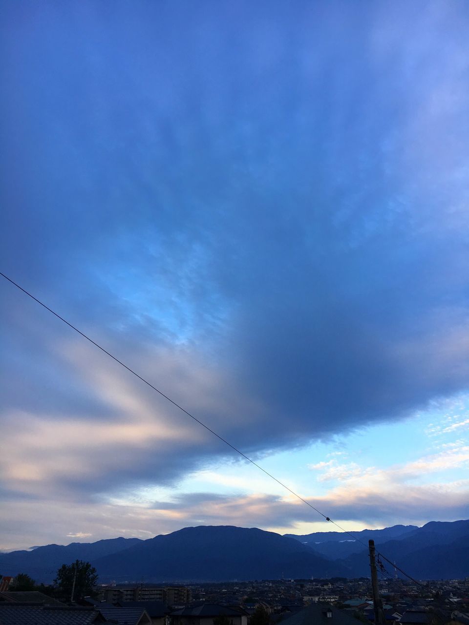 sky, cable, nature, mountain, cloud - sky, beauty in nature, scenics, outdoors, power line, blue, no people, sunset, vapor trail, landscape, electricity, mountain range, day, telephone line, contrail