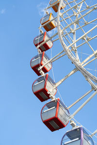 Closeup of multicolored tempozan ferris wheel in amusement park with blue sky in tbilisi, georgia