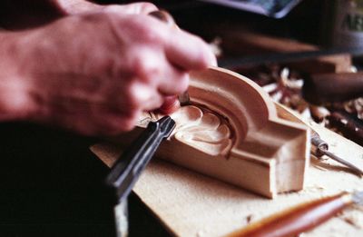 Close-up of man working on cutting board