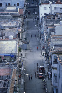 High angle view of vehicles on road along buildings