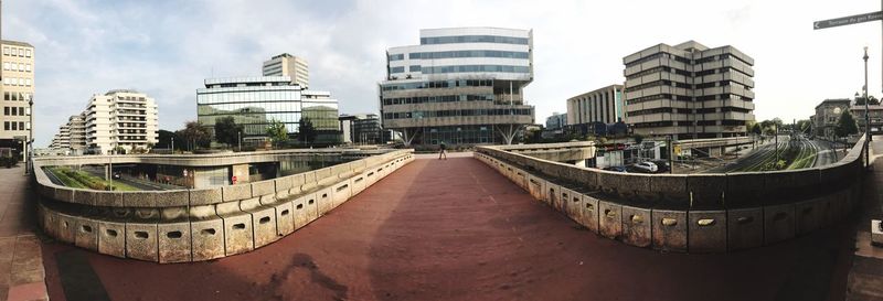 Panoramic shot of modern cityscape against sky