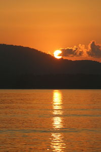 Scenic view of sea against romantic sky at sunset