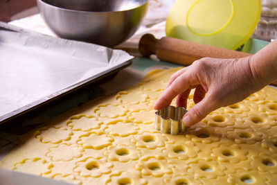 Midsection of person preparing food in kitchen