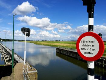 Road sign against sky