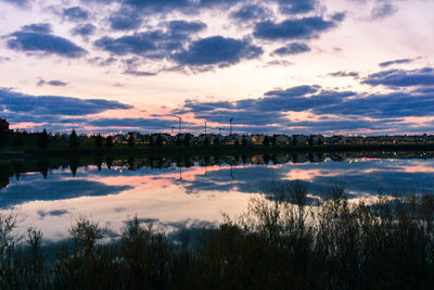 Scenic view of lake against sky during sunset