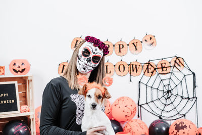 Low section of people with dog at home during halloween