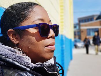 Close-up of woman wearing sunglasses and scarf