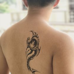 Rear view of shirtless man with tattoo