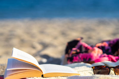 Close-up of books on beach