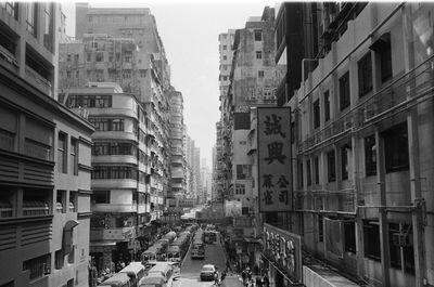 Vehicles on road amidst buildings in city