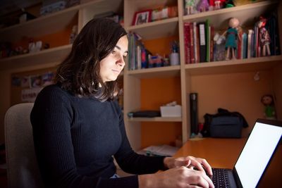 Woman using mobile phone at home