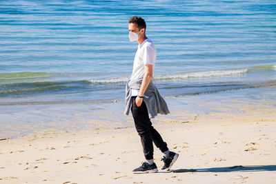 Full length of man walking on beach