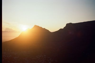 Scenic view of silhouette mountains against sky during sunset