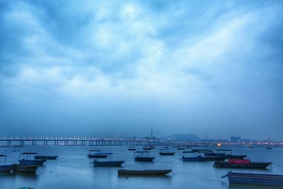 Boats moored at shore against cloudy sky at lau fau shan