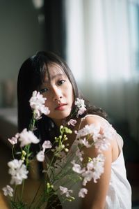 Portrait of woman with pink flowers