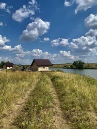 Houses on field against sky