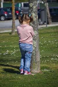 Rear view of woman standing on grass