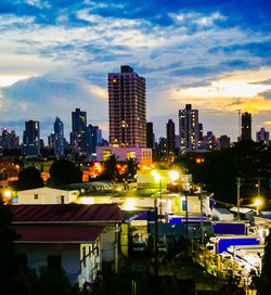 Illuminated cityscape against sky at night