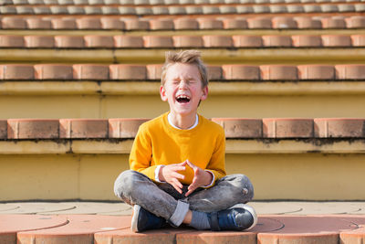 Smiling boy sitting outdoors