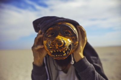 Close-up portrait of man against sky