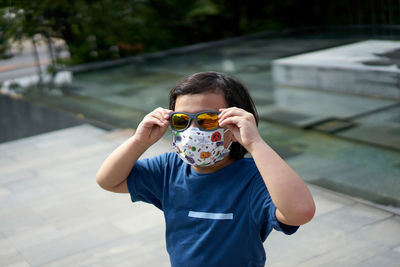 Portrait of asian boy wear mask outside for protect covid-19