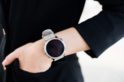 Midsection of woman wearing smart watch