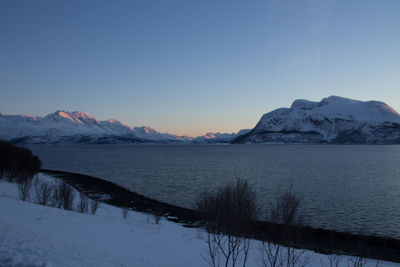 Scenic view of snowcapped mountains against clear sky