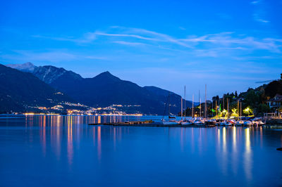 The town of pianello del lario, on lake como, and the promenade along the lake, at dusk.