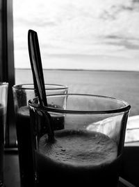 Empty chairs and tables at seaside