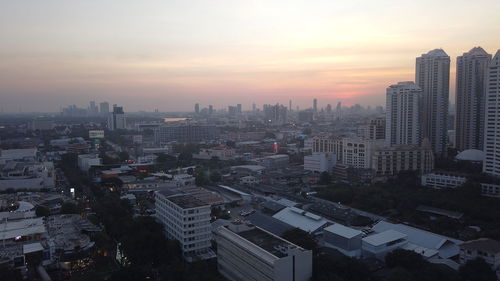 High angle view of modern buildings against sky during sunset