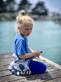 Boy sitting in lake