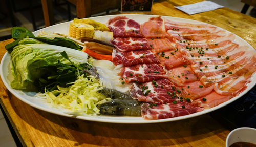 High angle view of chopped vegetables in bowl on table