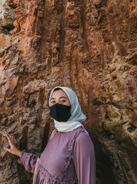 Portrait of woman standing on rock