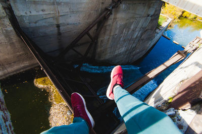 Low section of man sitting at abandoned building 