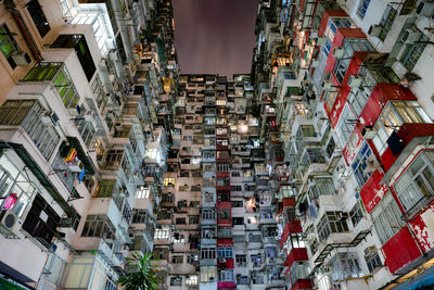 Low angle view of buildings in city at night